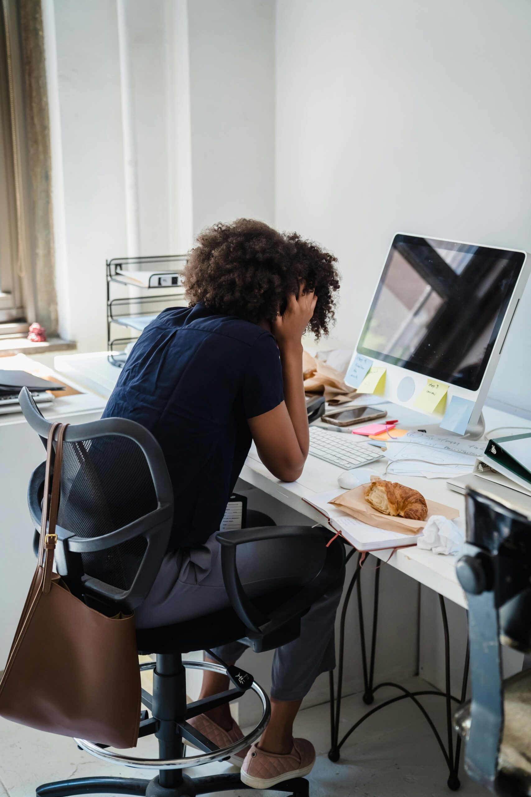Desk Job Pain in Ottawa: Why Sitting All Day Is Causing Your Pain (And How Physiotherapy Fixes It) 1 Office worker with neck pain at desk in Ottawa